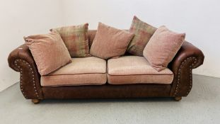 A MODERN THREE SEATER OATMEAL UPHOLSTERED SOFA WITH TAN LEATHER ARMS.