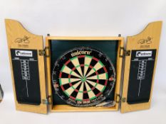 A CABINET MOUNTED UNICORN DARTBOARD BY PHIL TAYLOR.