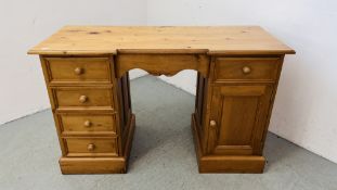 A WAXED SOLID PINE TWIN PEDESTAL DESK / DRESSING TABLE W 130CM, D 53CM, H 81CM.