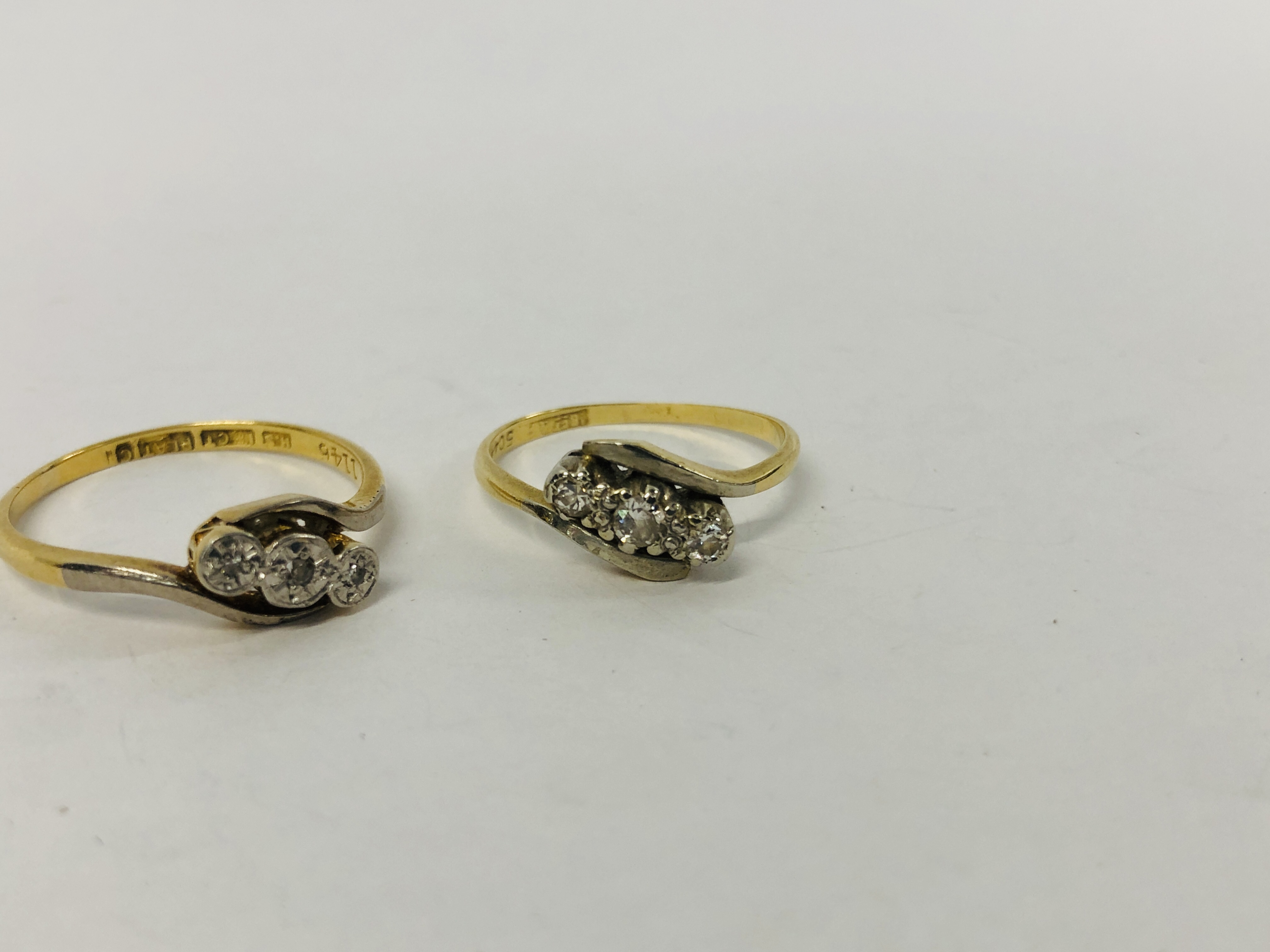 TWO 18CT. AND PLATINUM THREE STONE DIAMOND CROSS OVER RINGS. - Image 2 of 10