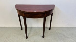 A GEORGE III MAHOGANY DEMI LUNE FOLDING TEA TABLE, D 89.5CM.