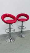 A PAIR OF RISE AND FALL RED FAUX LEATHER BAR STOOLS ON CHROME BASE