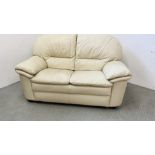 A CREAM LEATHER TWO SEATER SOFA.