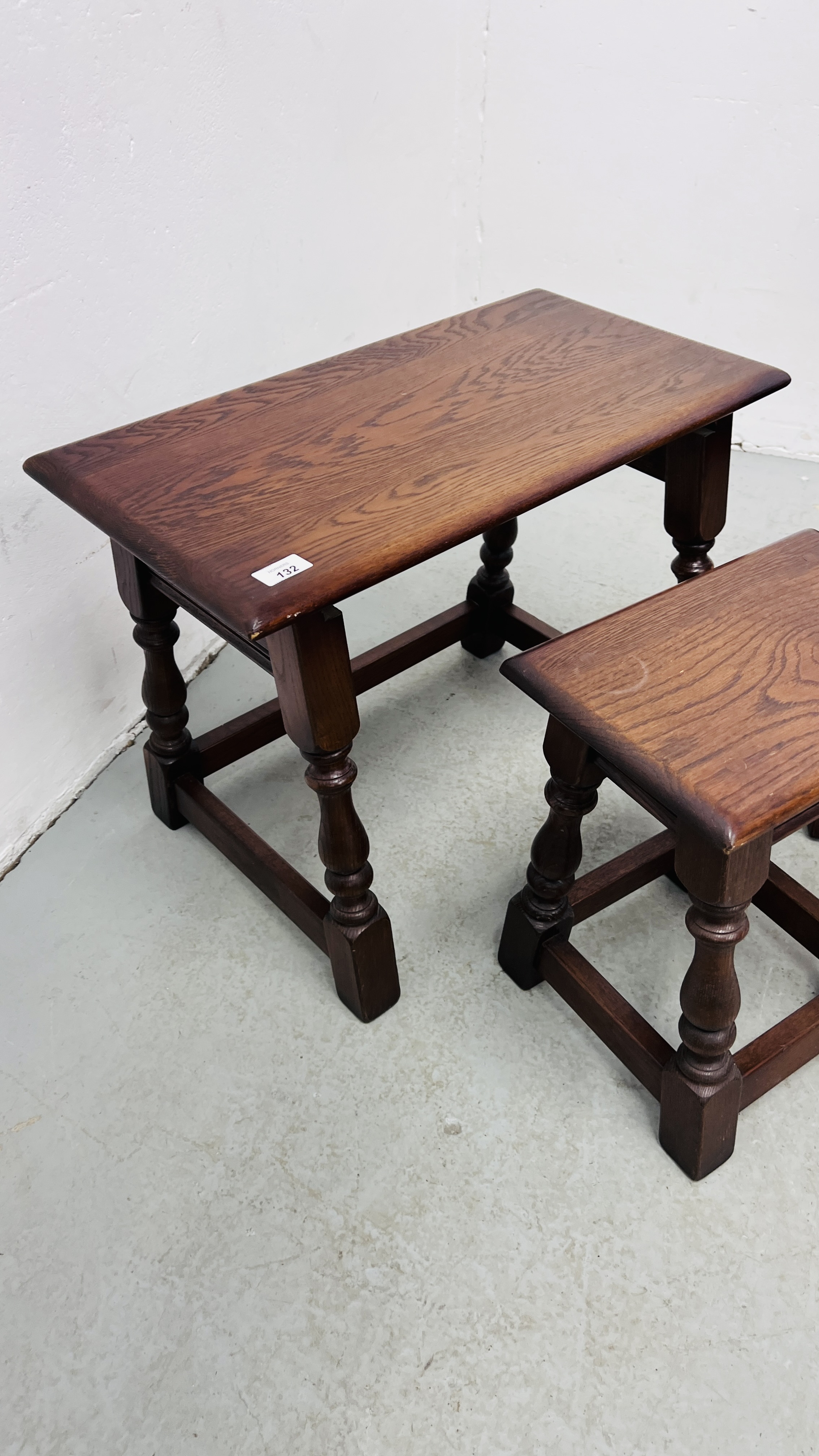 A NEST OF THREE REPRODUCTION GOOD QUALITY OAK TABLES (THE LARGEST 60CM. X 32CM. - Image 4 of 8