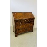 A GEORGE II FIGURED WALNUT BUREAU, THE FALLING FRONT ENCLOSING FITTED INTERIOR,