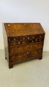 A GEORGE II FIGURED WALNUT BUREAU, THE FALLING FRONT ENCLOSING FITTED INTERIOR,