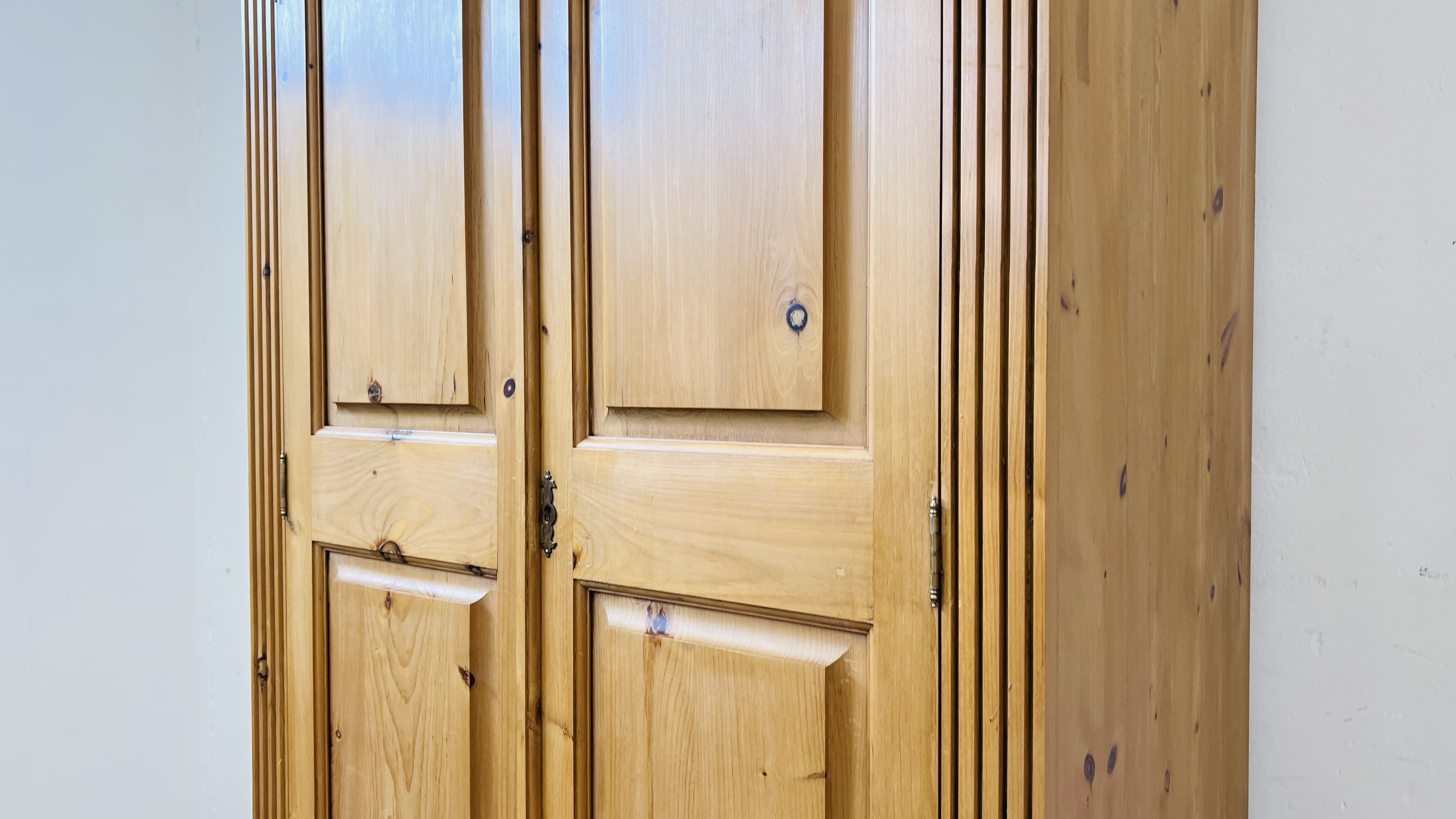 A GOOD QUALITY SOLID PINE TWO DOOR WARDROBE ON SINGLE DRAWER BASE W 102CM X D 60CM X H 194CM. - Image 3 of 8