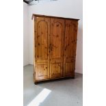 A GOOD QUALITY HONEY PINE TRIPLE DOOR WARDROBE WIDTH 137 CM. DEPTH 56CM. HEIGHT 190CM.