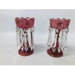 A PAIR OF PINK AND GILT DECORATED GLASS LUSTERS.