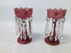 A PAIR OF PINK AND GILT DECORATED GLASS LUSTERS.