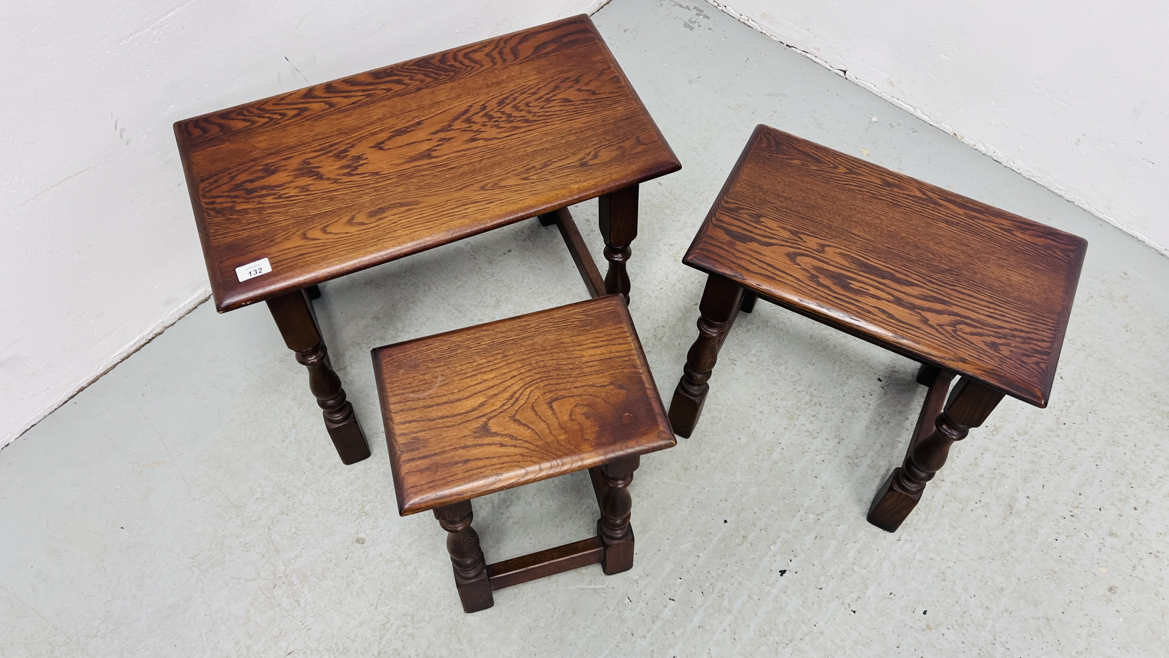 A NEST OF THREE REPRODUCTION GOOD QUALITY OAK TABLES (THE LARGEST 60CM. X 32CM. - Image 8 of 8