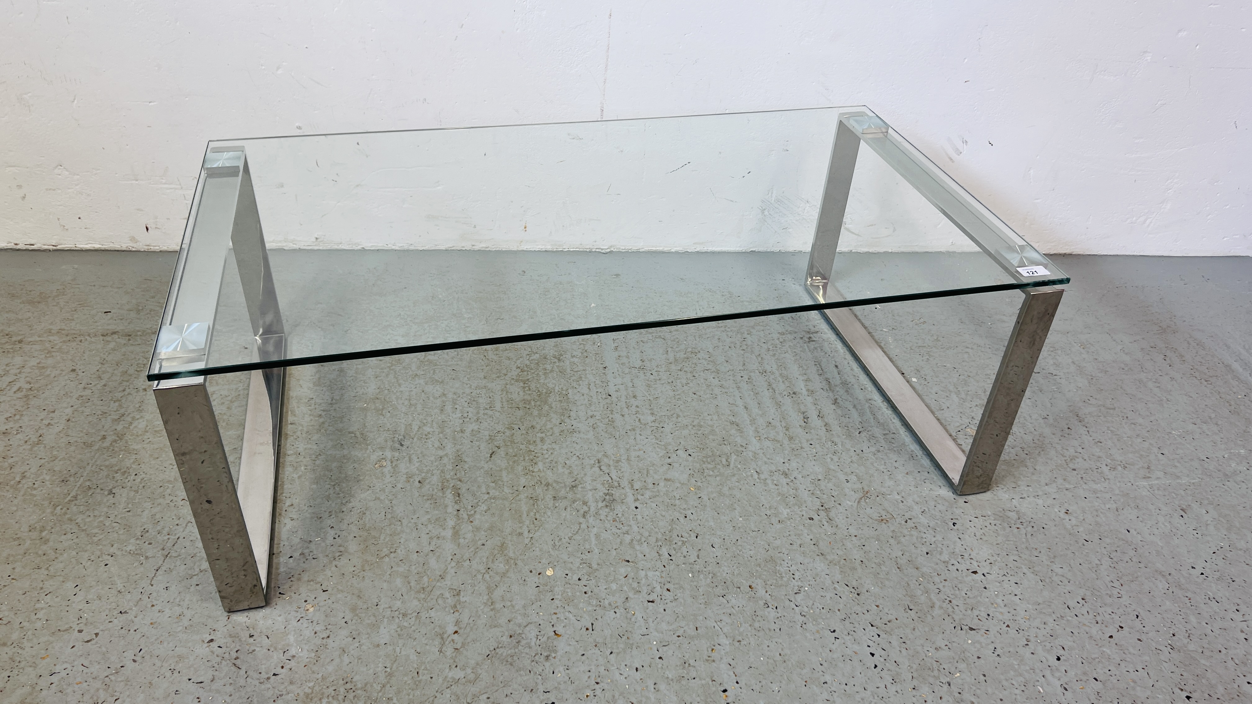 DESIGNER GLASS TOPPED COFFEE TABLE ON CHROME LEGS WIDTH 110CM. DEPTH 60CM. HEIGHT 38CM.