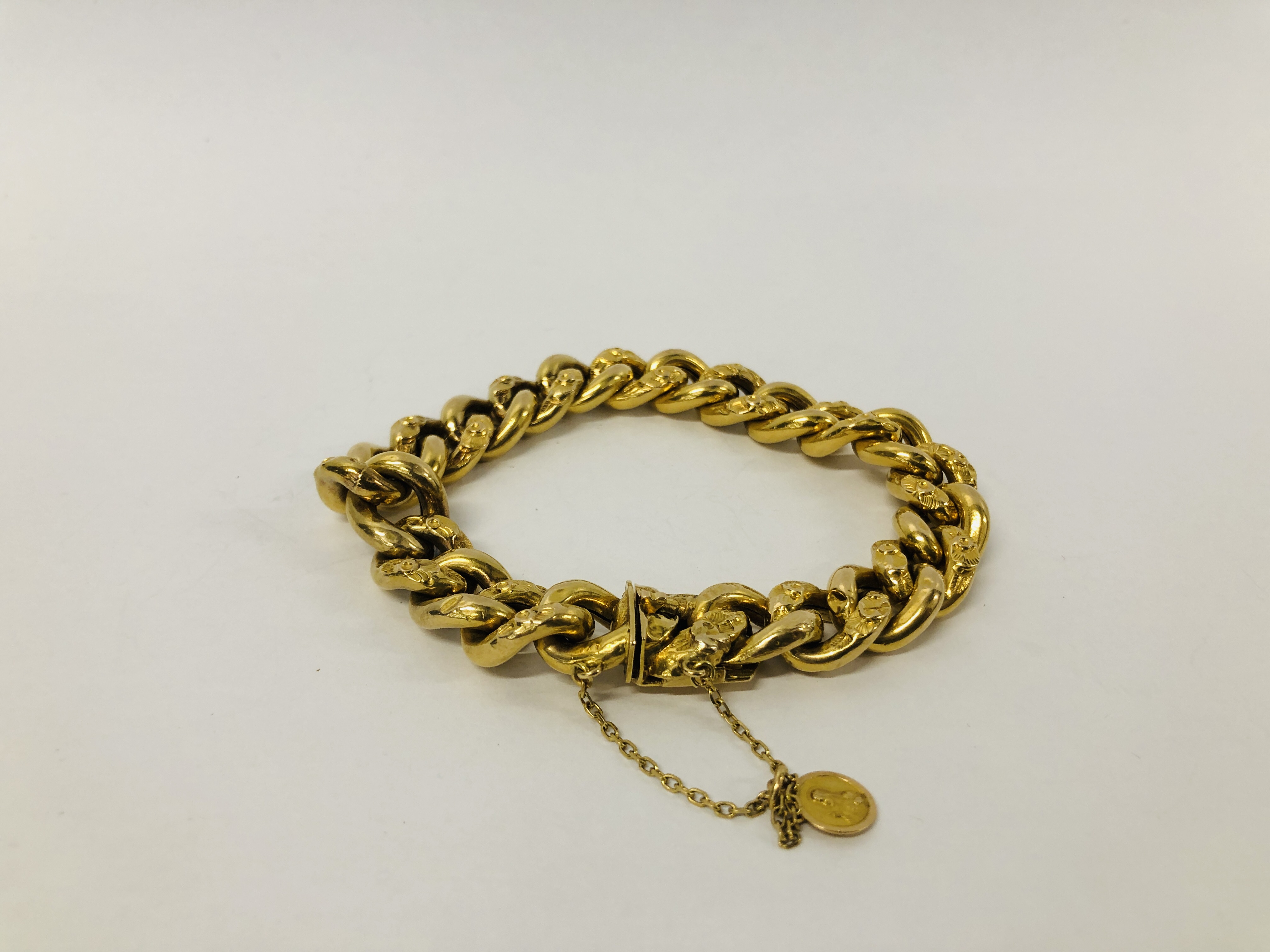 VINTAGE YELLOW METAL CURB BRACELET WITH SAFETY CHAIN (INDISTINCT MARKS).