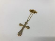 AN ELEGANT YELLOW METAL (INDISTINCT MARKS) STONE SET CROSS PENDANT ON A FINE YELLOW METAL CHAIN.