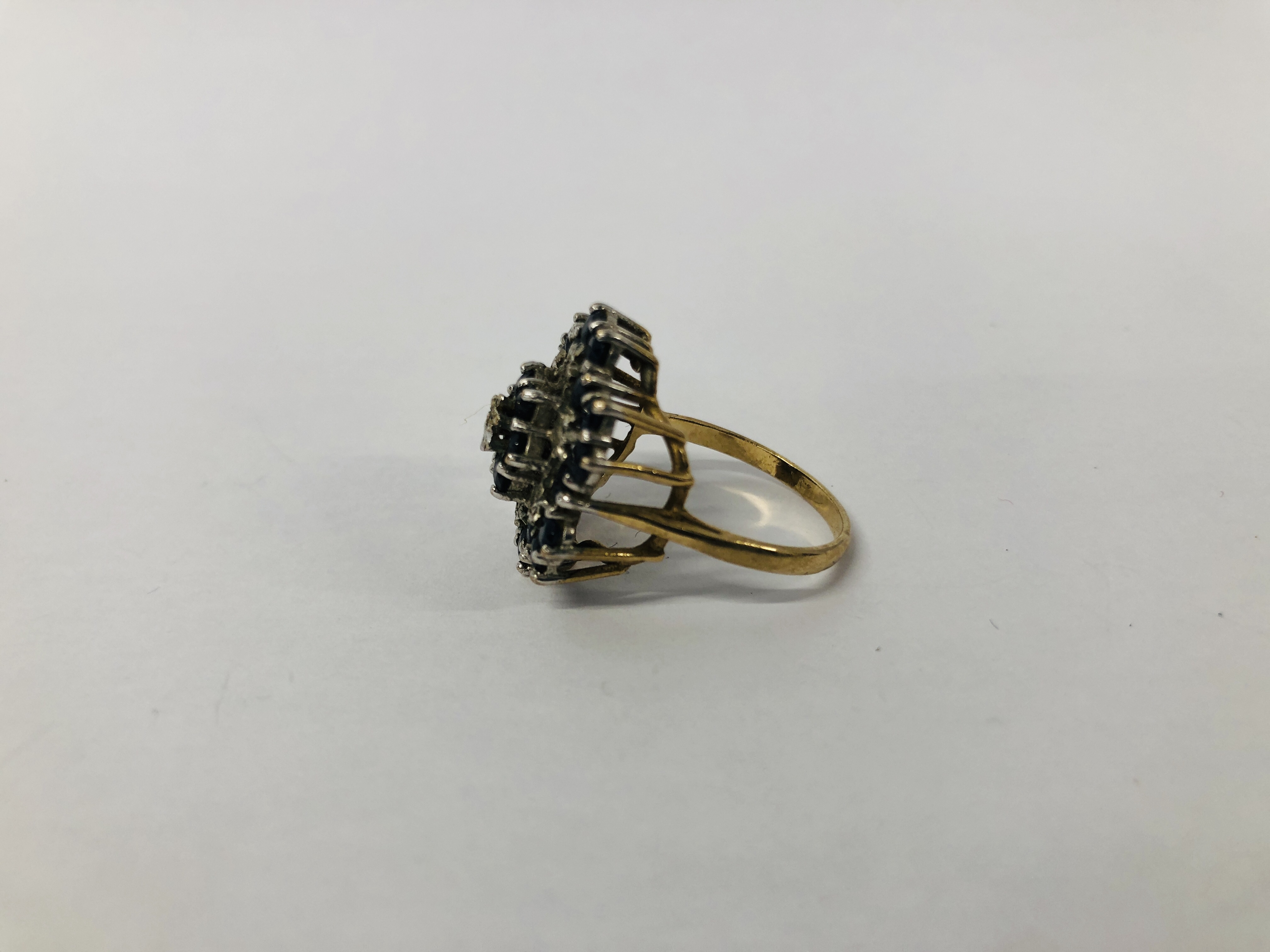 A 9CT. GOLD DIAMOND AND SAPPHIRE RING, SETTING OF FLOWER HEAD DESIGN. - Image 3 of 7