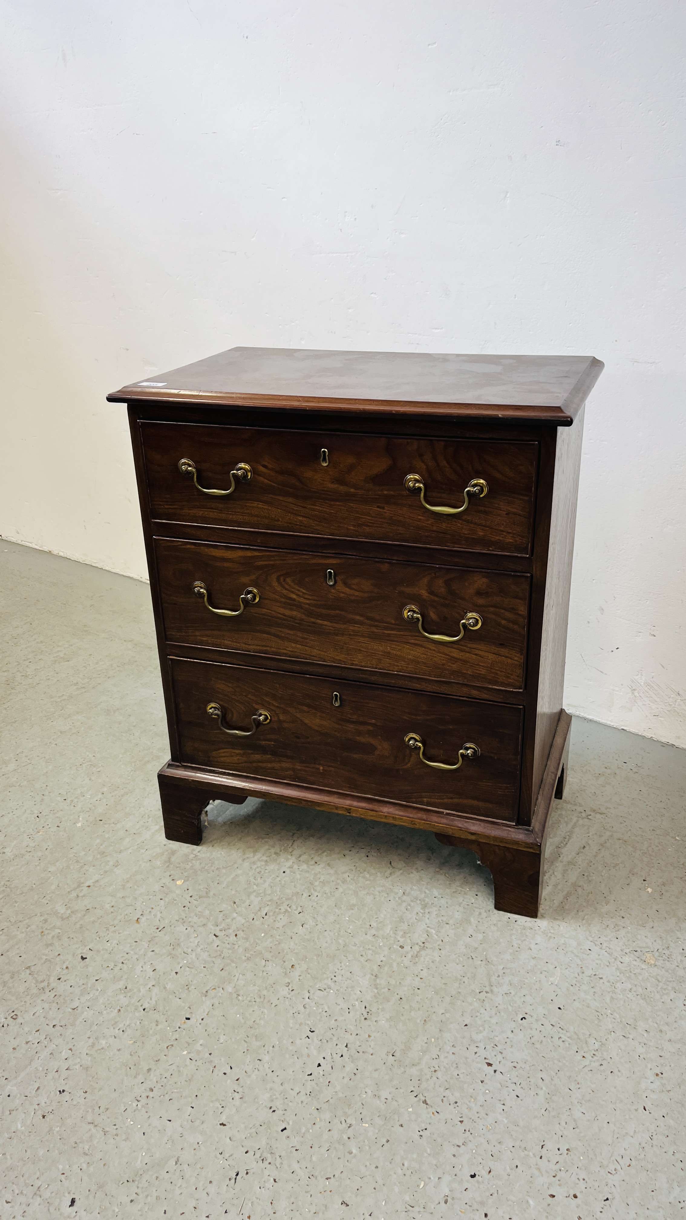 A MAHOGANY THREE DRAWER CHEST, GEORGIAN AND LATER, W 66CM.