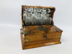 A VICTORIAN OAK CASED MIRRORED BACK BRASS DETAILED TANTALUS COMPLETE WITH THREE GLASS DECANTERS