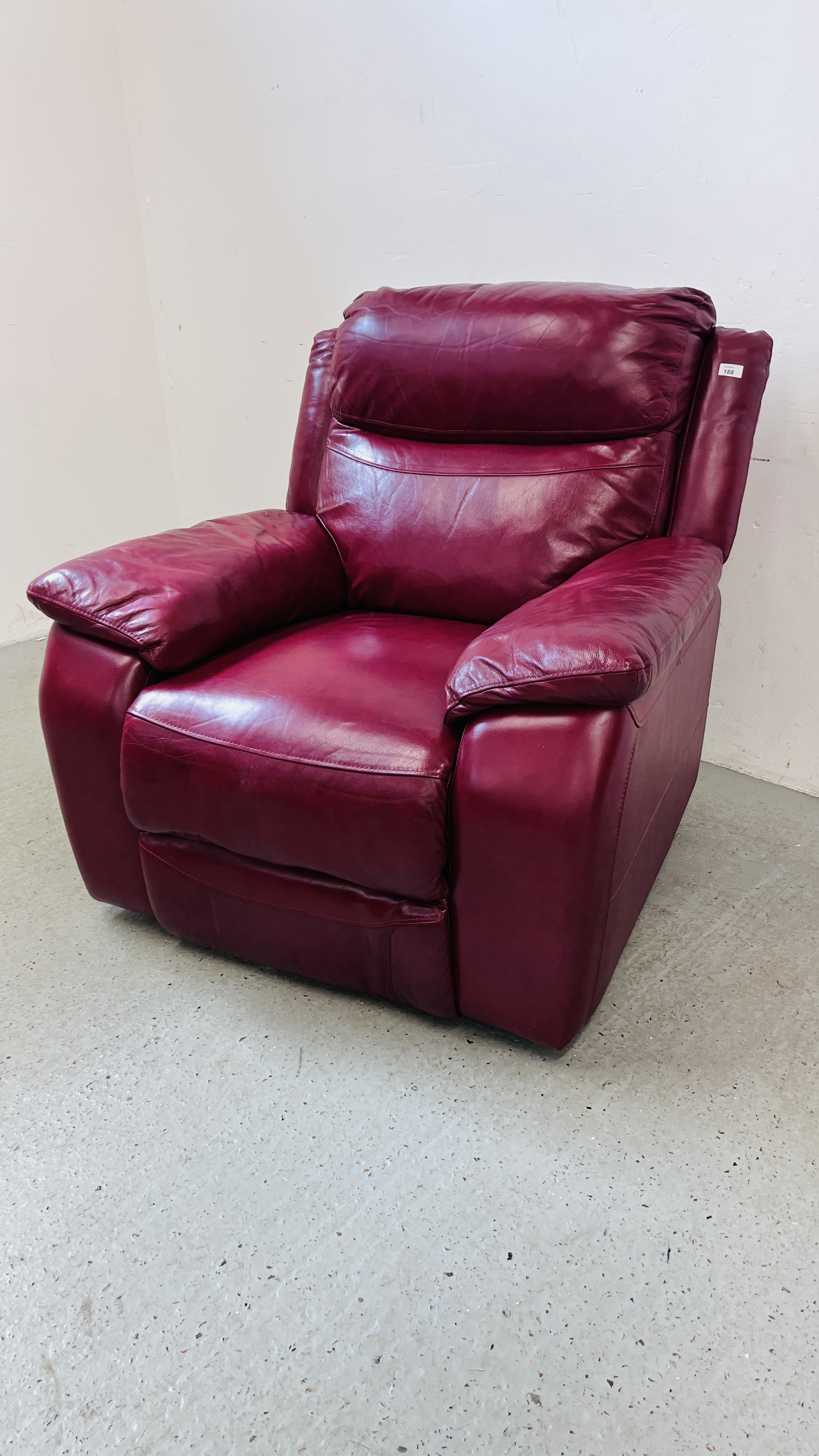 A RED LEATHER ELECTRIC RECLINING EASY CHAIR - SOLD AS SEEN.