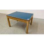 A MID CENTURY OAK FRAMED OCCASIONAL TABLE WITH BLUE TOP BEARING LABEL GORDON RUSSELL LIMITED