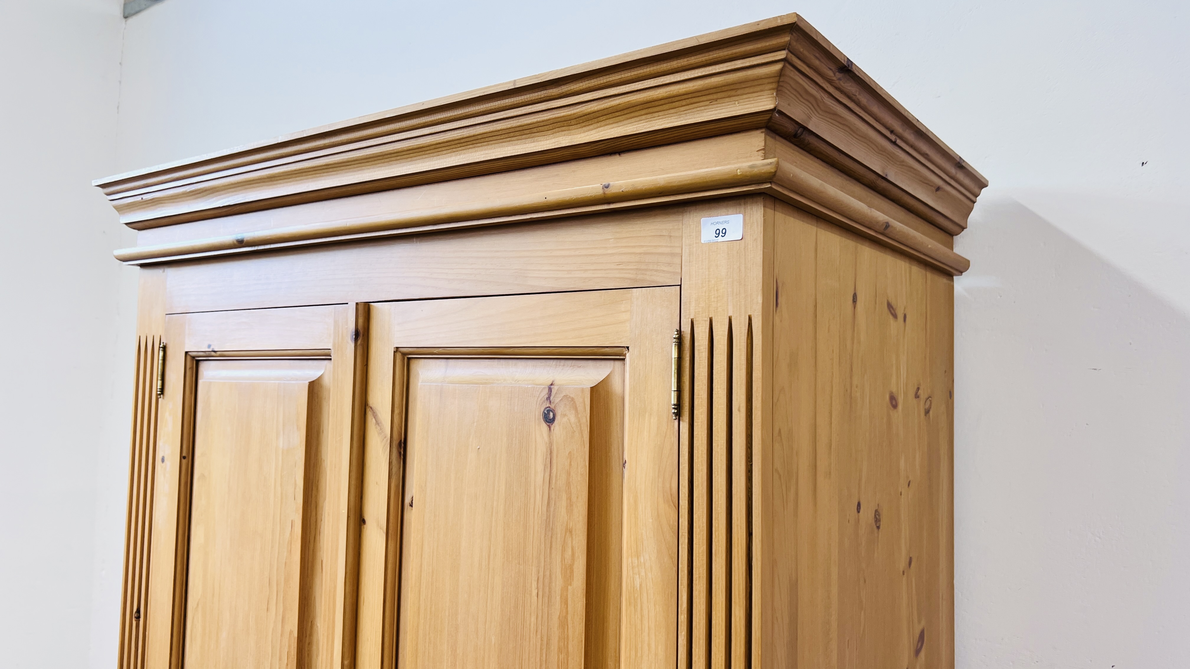 A GOOD QUALITY SOLID PINE TWO DOOR WARDROBE ON SINGLE DRAWER BASE W 102CM X D 60CM X H 194CM. - Image 2 of 8