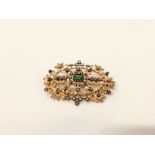 DESIGNER GILT BROOCH SET WITH CENTRAL GREEN STONE AND MULTIPLE CLEAR STONES, MARKED "ART JOY".