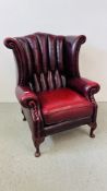 A CHESTERFIELD WING BACKED ARM CHAIR IN OXBLOOD RED FINISH - TRADE ONLY