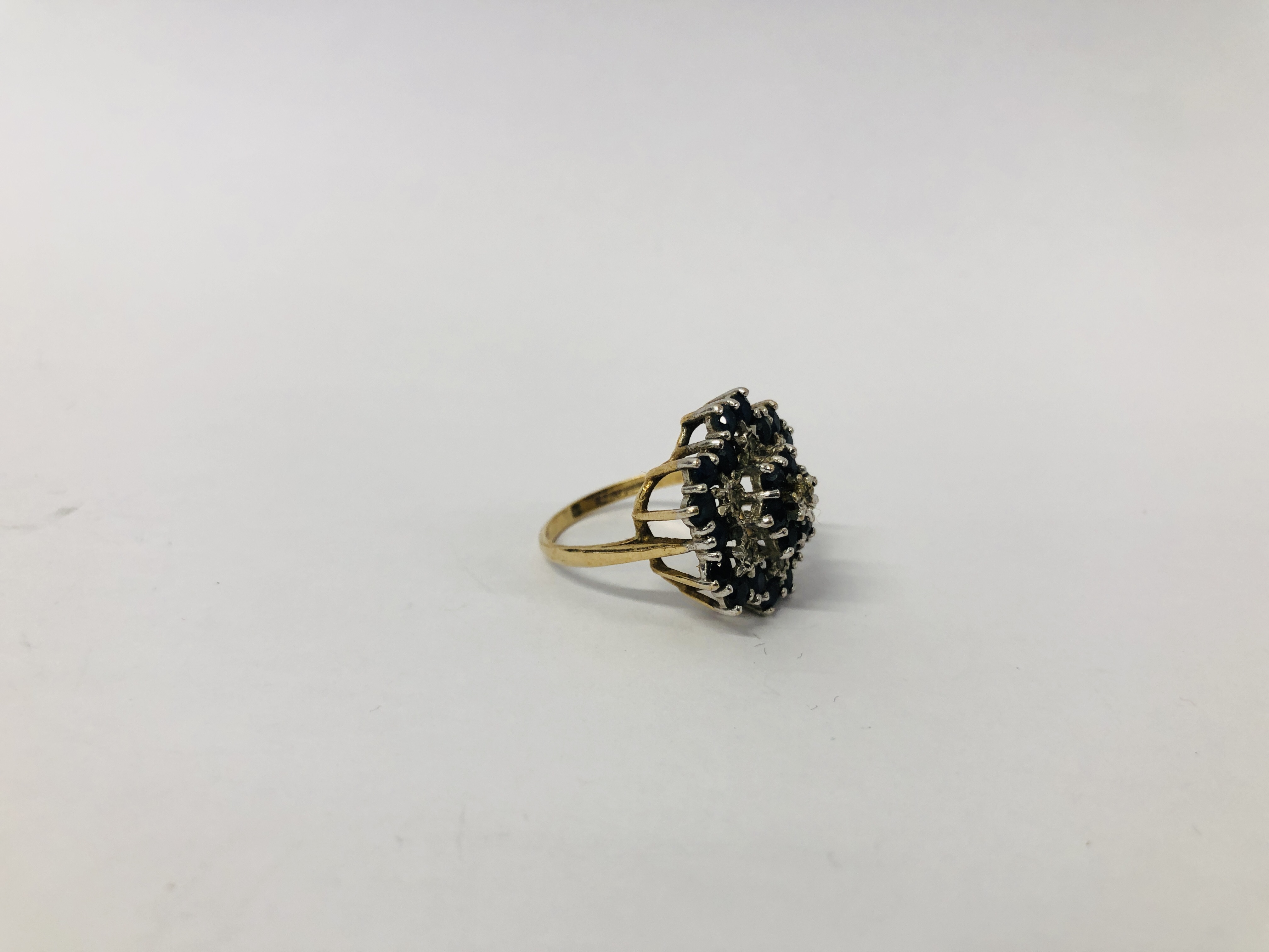 A 9CT. GOLD DIAMOND AND SAPPHIRE RING, SETTING OF FLOWER HEAD DESIGN. - Image 2 of 7