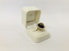 A VINTAGE VICTORIAN DESIGN 9CT. GOLD AMETHYST AND SEED PEARL RING OF RAISED FORM.