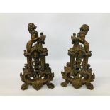 A PAIR OF ORNATE HEAVY BRASS FIRE DOGS H 35CM.
