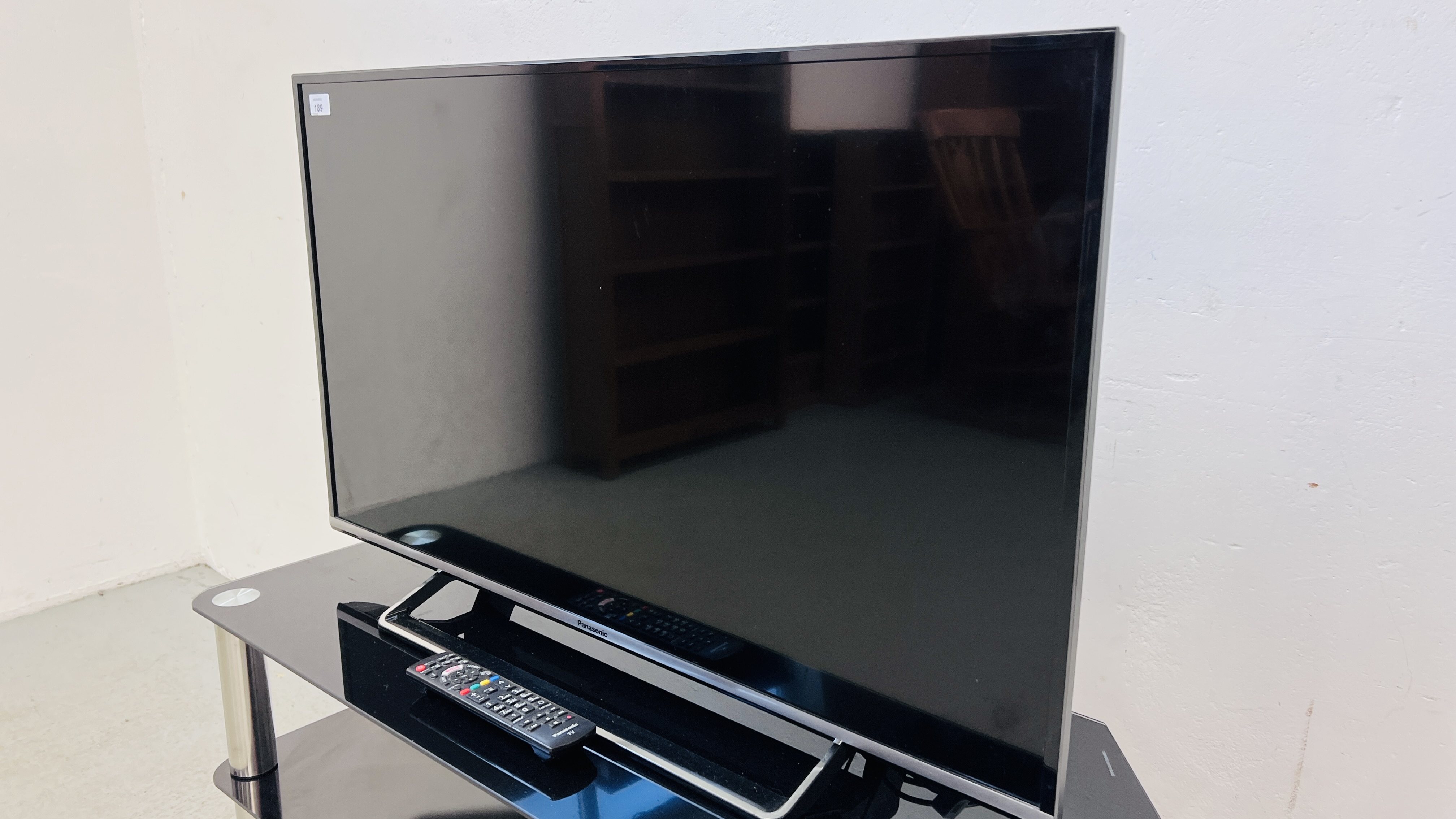 A PANASONIC 40 INCH LED TELEVISION ON THREE TIER GLASS STAND COMPLETE WITH REMOTE - SOLD AS SEEN. - Image 2 of 5