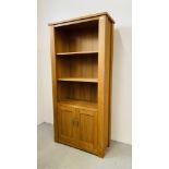 A MODERN SOLID OAK NEXT SHELVED UNIT WITH TWO DOOR CABINET BASE 87CM X 37CM X 191CM.