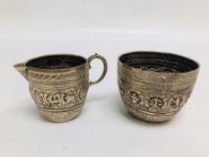 AN UNUSUAL SILVER SUGAR BOWL AND CREAM JUG EMBOSSED DECORATION DEPICTING ANIMALS,