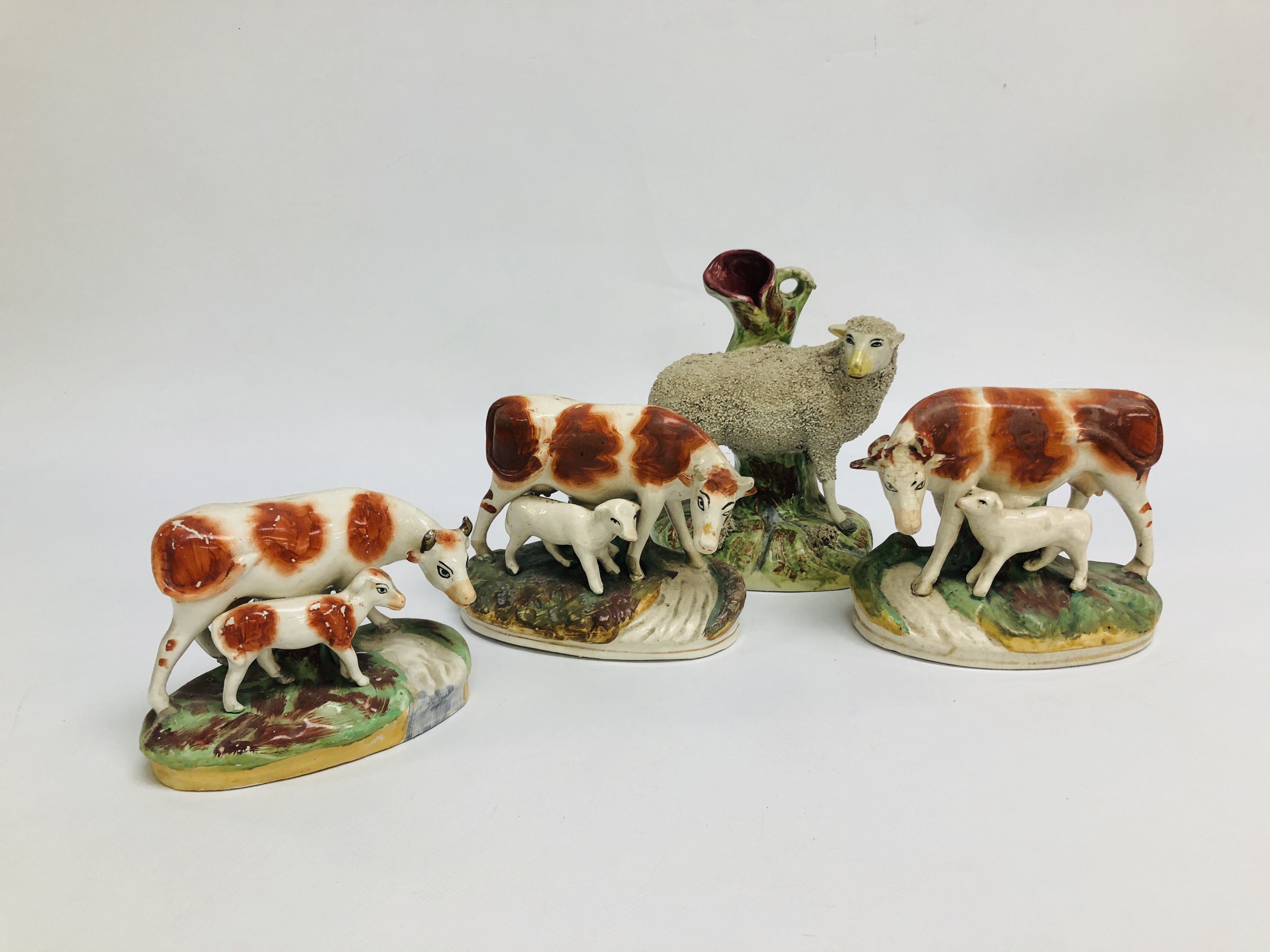THREE STAFFORDSHIRE MODELS OF COWS AND CALVES, EACH COW HAVING A CALF,