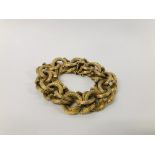 AN IMPRESSIVE 9CT. GOLD HEAVY BRACELET OF INTERWOVEN DESIGN, WITH SAFETY CHAIN.