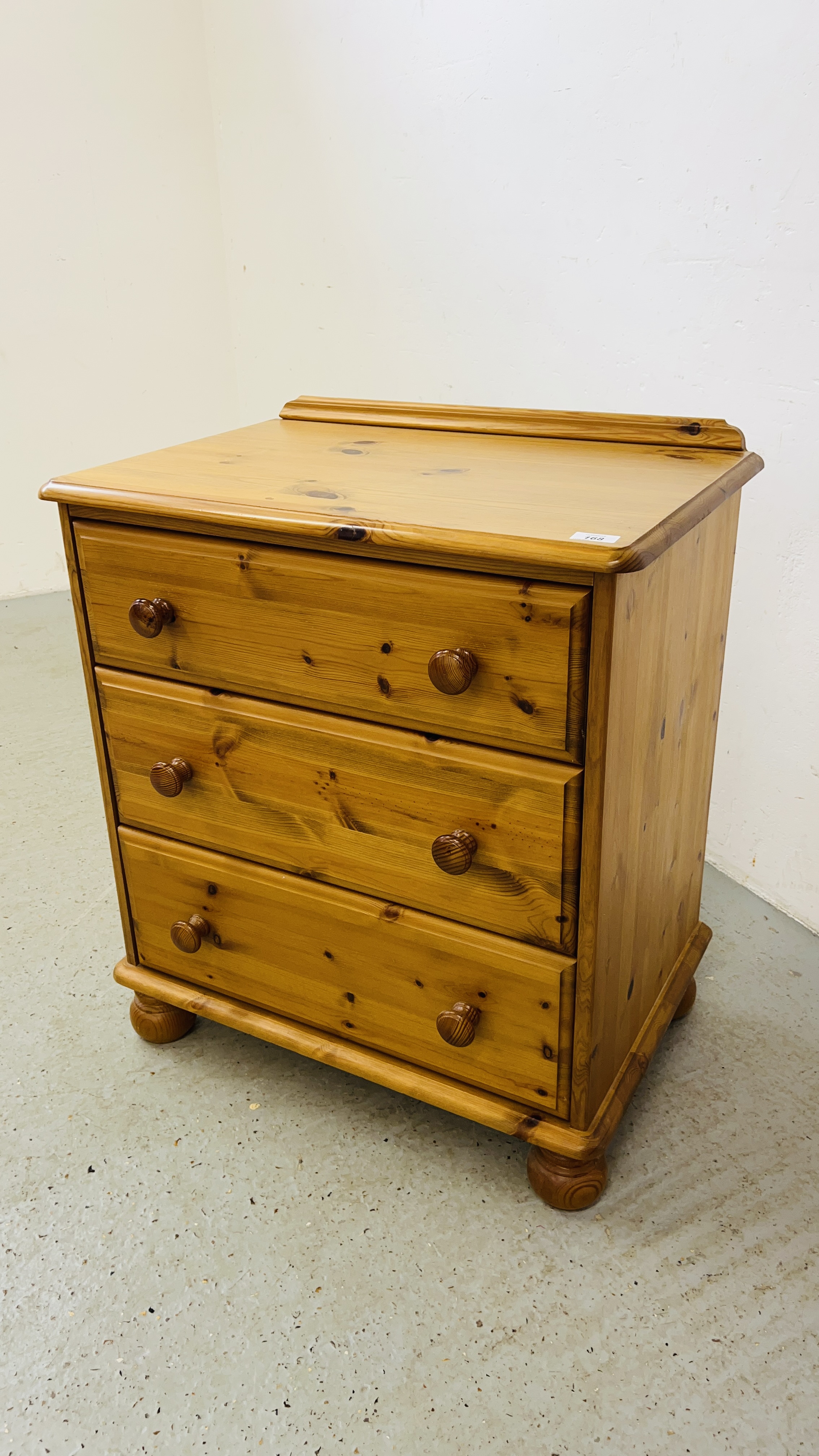 A GOOD QUALITY HONEY PINE THREE DRAWER CHEST OF DRAWERS WIDTH 67CM. DEPTH 46CM. HEIGHT 77CM.