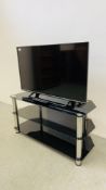 A PANASONIC 40 INCH LED TELEVISION ON THREE TIER GLASS STAND COMPLETE WITH REMOTE - SOLD AS SEEN.