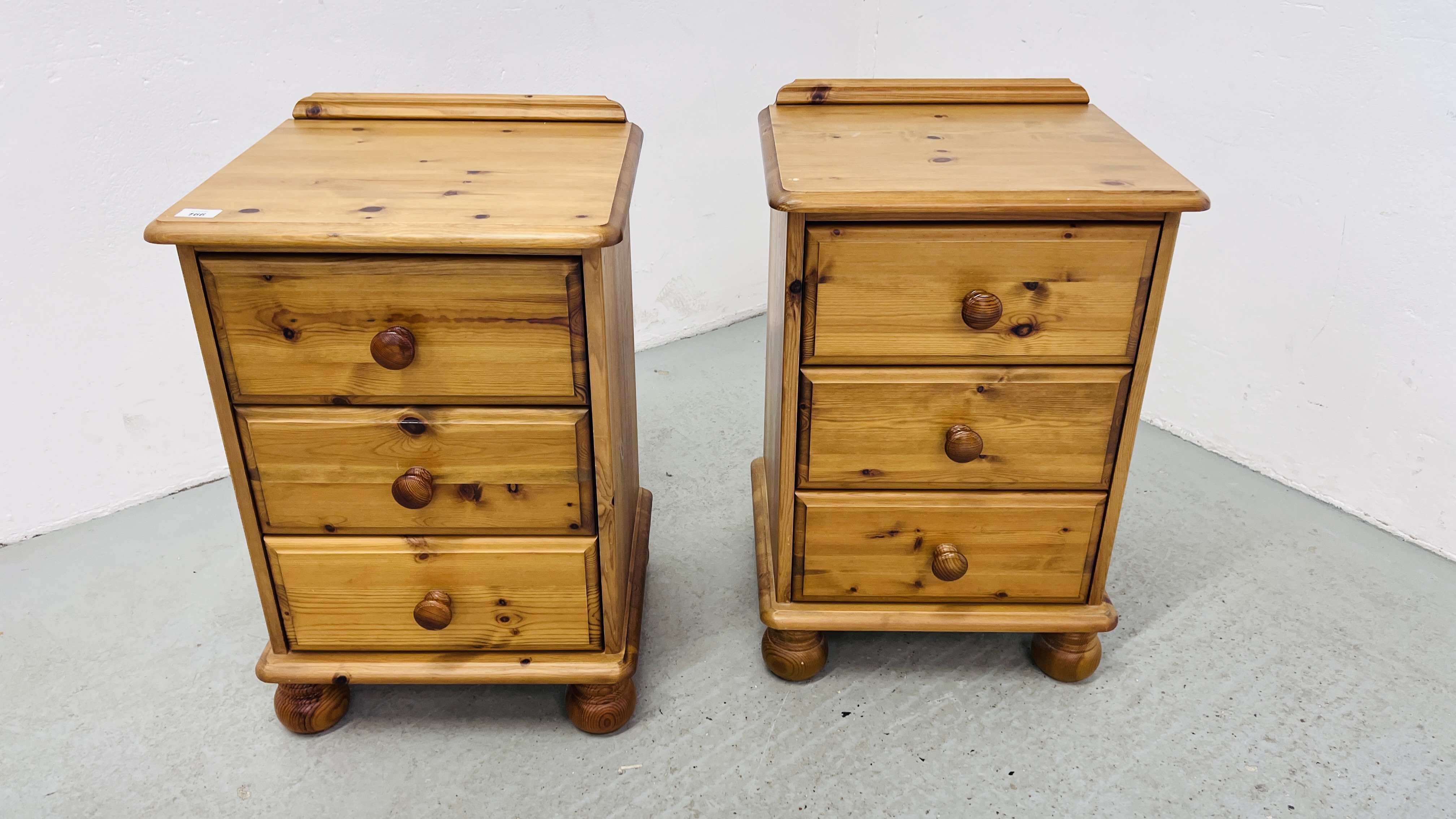 A PAIR OF GOOD QUALITY HONEY PINE THREE DRAWER BEDSIDE CABINETS WIDTH 46CM. DEPTH 40CM. HEIGHT 70CM.