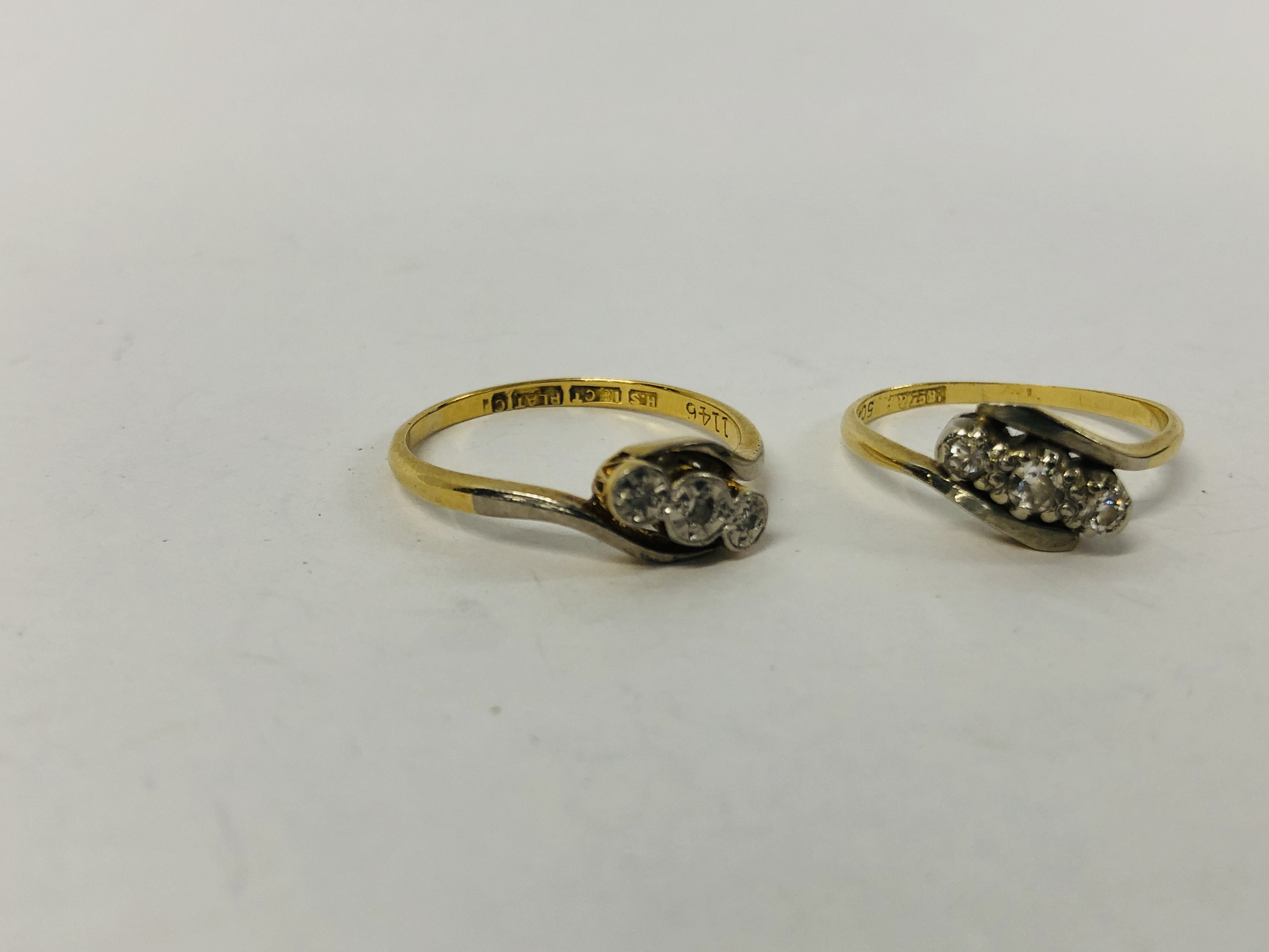 TWO 18CT. AND PLATINUM THREE STONE DIAMOND CROSS OVER RINGS. - Image 3 of 10