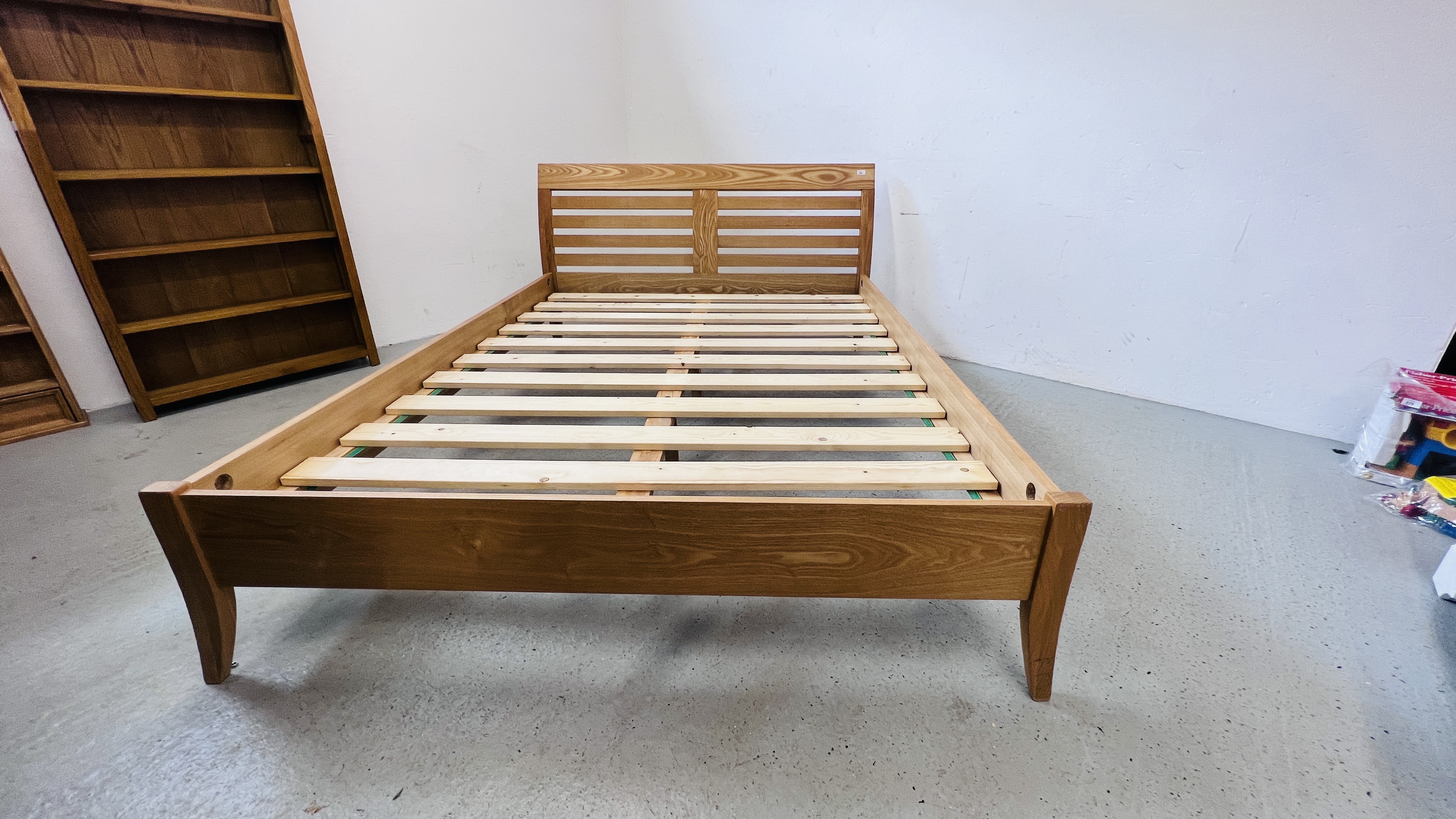 A MODERN LIGHT OAK FINISH KINGSIZE SLEIGH BEDSTEAD.