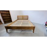 A MODERN LIGHT OAK FINISH KINGSIZE SLEIGH BEDSTEAD.