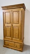 A GOOD QUALITY SOLID PINE TWO DOOR WARDROBE ON SINGLE DRAWER BASE W 102CM X D 60CM X H 194CM.