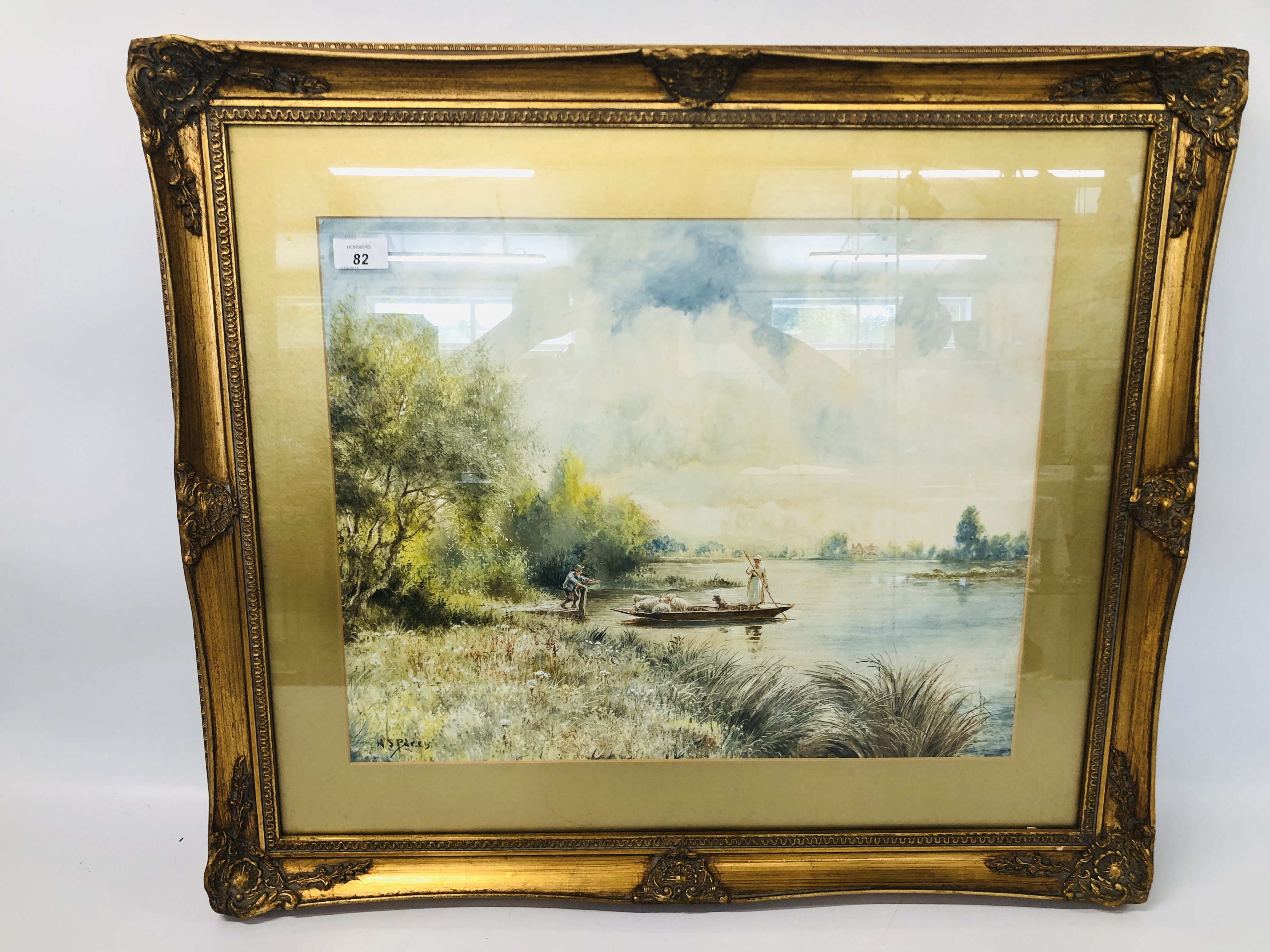 A FRAMED AND MOUNTED WATERCOLOUR OF A SHEPHERDESS MOVING HER SHEEP OVER THE LAKE BEARING SIGNATURE