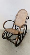A BENTWOOD ROCKING CHAIR WITH RATTAN SEAT AND BACK