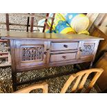 A REPRODUCTION OAK SIDEBOARD STANDING ON TURNED LEGS,