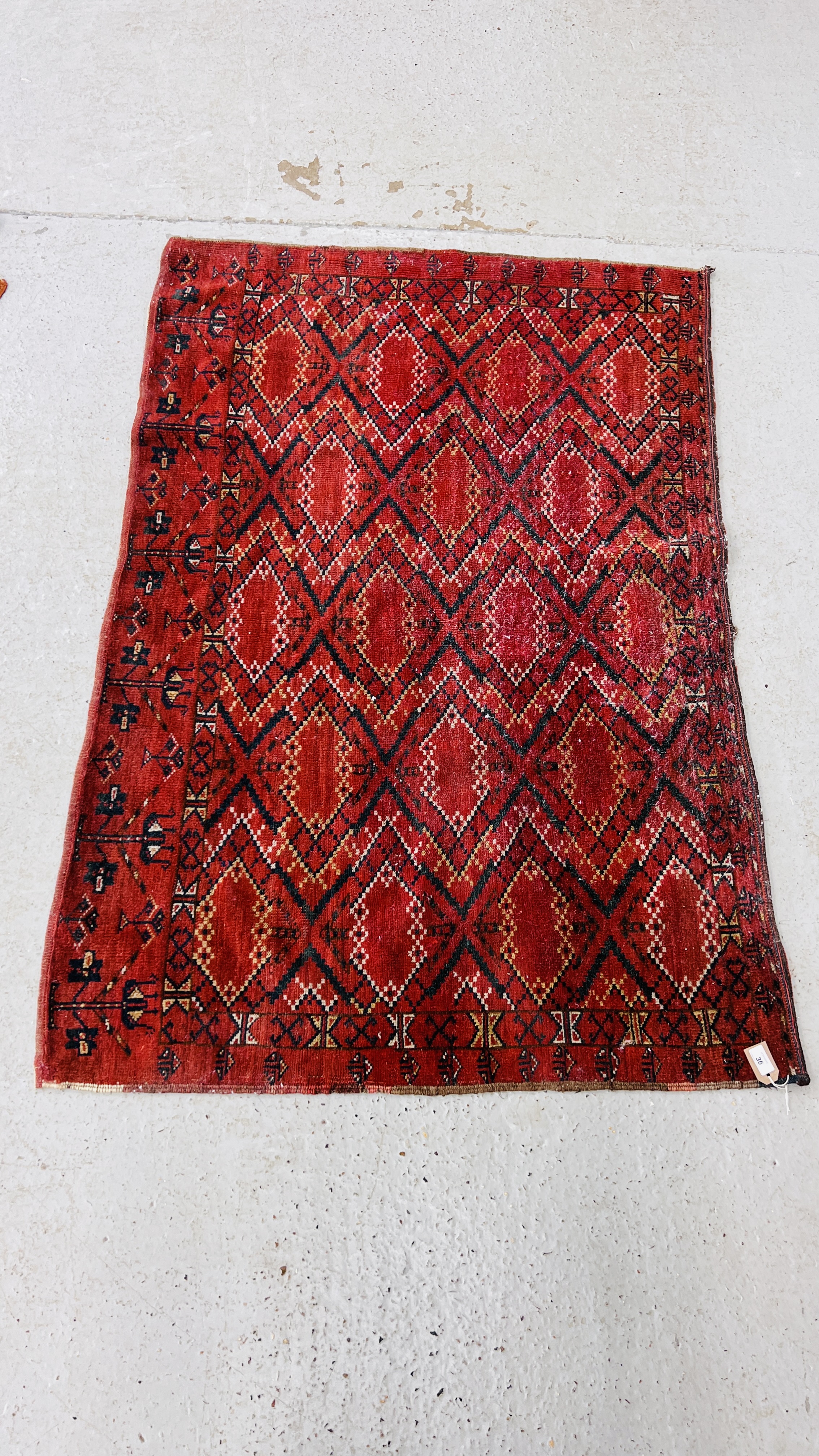 A TURKOMAN RUG, PROBABLY A DUVAL THE BRICK RED FIELD WITH GEOMETRIC LOZENGES 159CM X 109CM.