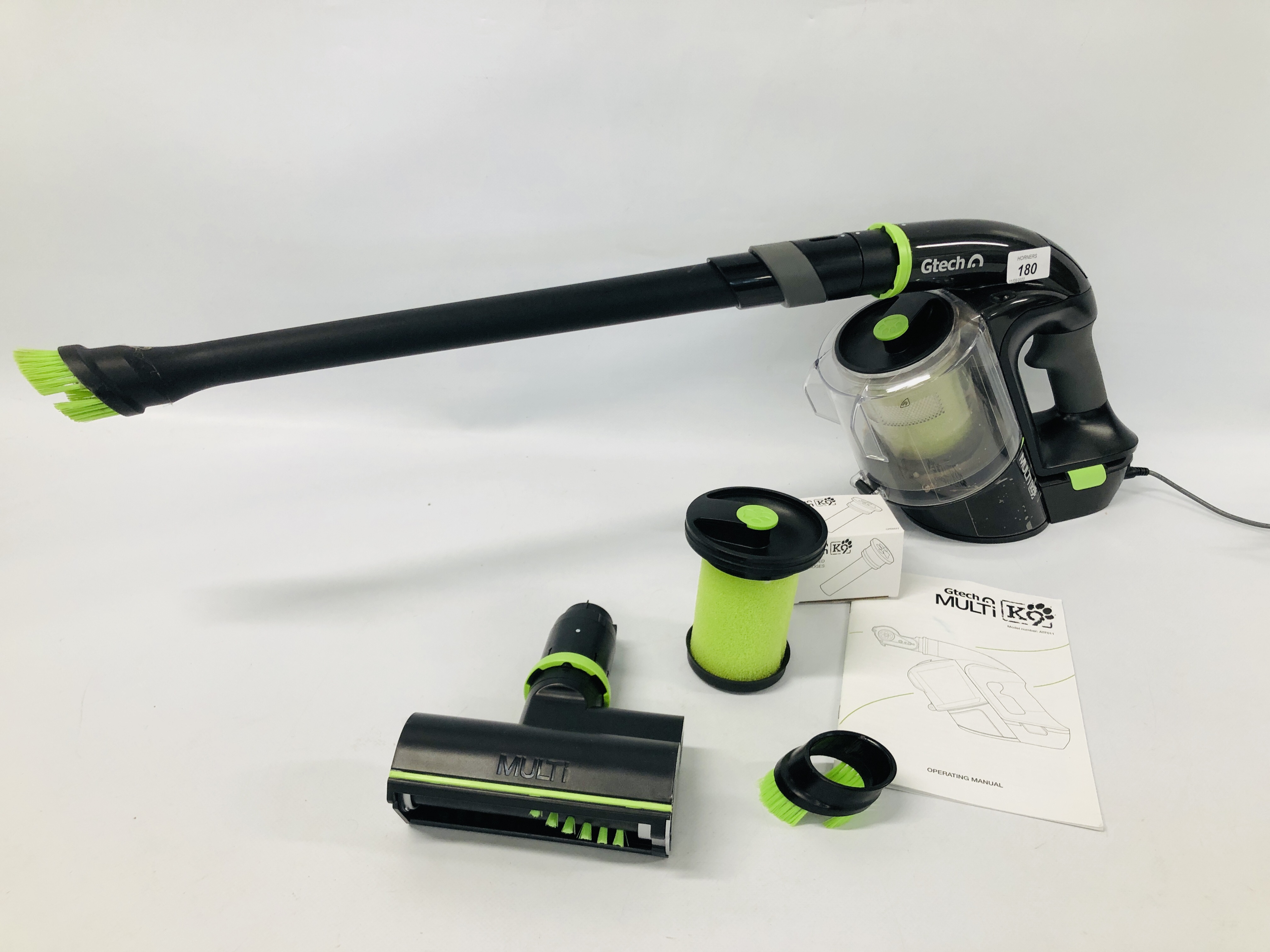 A GTECH MULTI K9 CORDLESS HAND HELD VACUUM WITH ACCESSORIES AND HANDBOOK - SOLD AS SEEN.