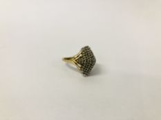 AN ART DECO STYLE DIAMOND CLUSTER RING OF RAISED FORM IN 9CT. GOLD SETTING.