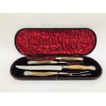 A VINTAGE HORN HANDLED FOUR PIECE CARVING SET WITH SILVER FINIALS AND BANDING IN A FITTED CASE