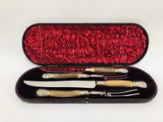 A VINTAGE HORN HANDLED FOUR PIECE CARVING SET WITH SILVER FINIALS AND BANDING IN A FITTED CASE