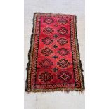 A BOKHARA RUG THE HOOKED LOZENGES ON A RED FIELD,